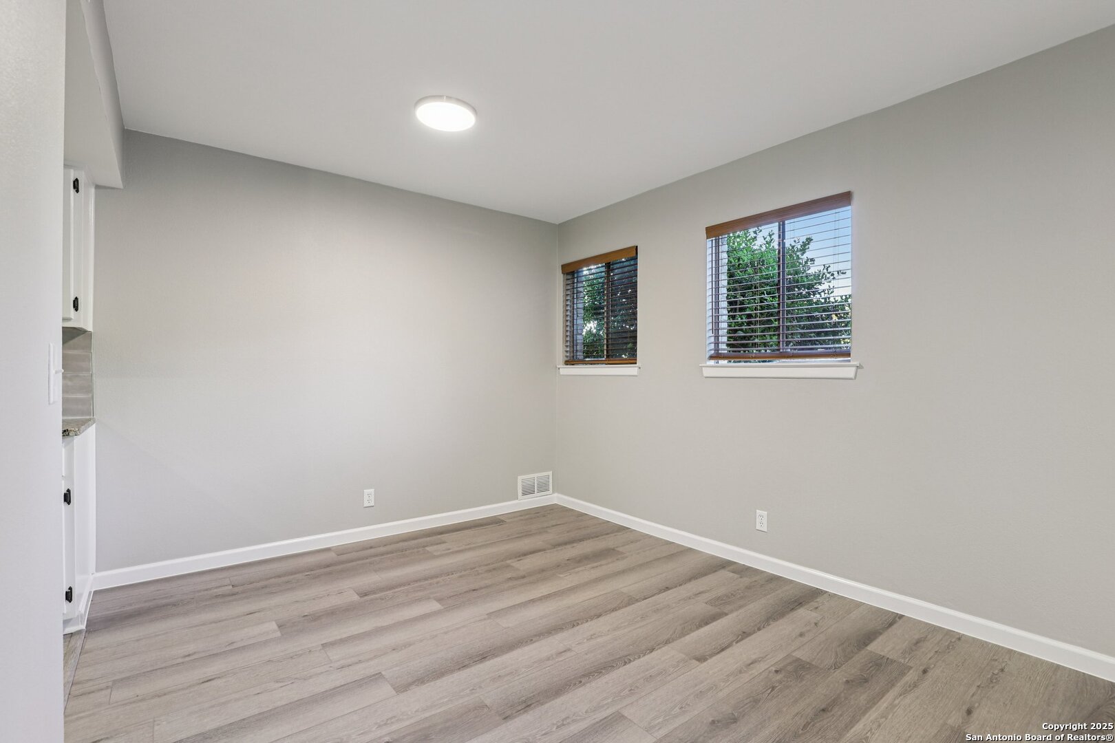 3441 Turtle Village Drive, Unit 92FF San Antonio, TX 78230 - Photo 11 of 34 an empty room with wooden floor and windows