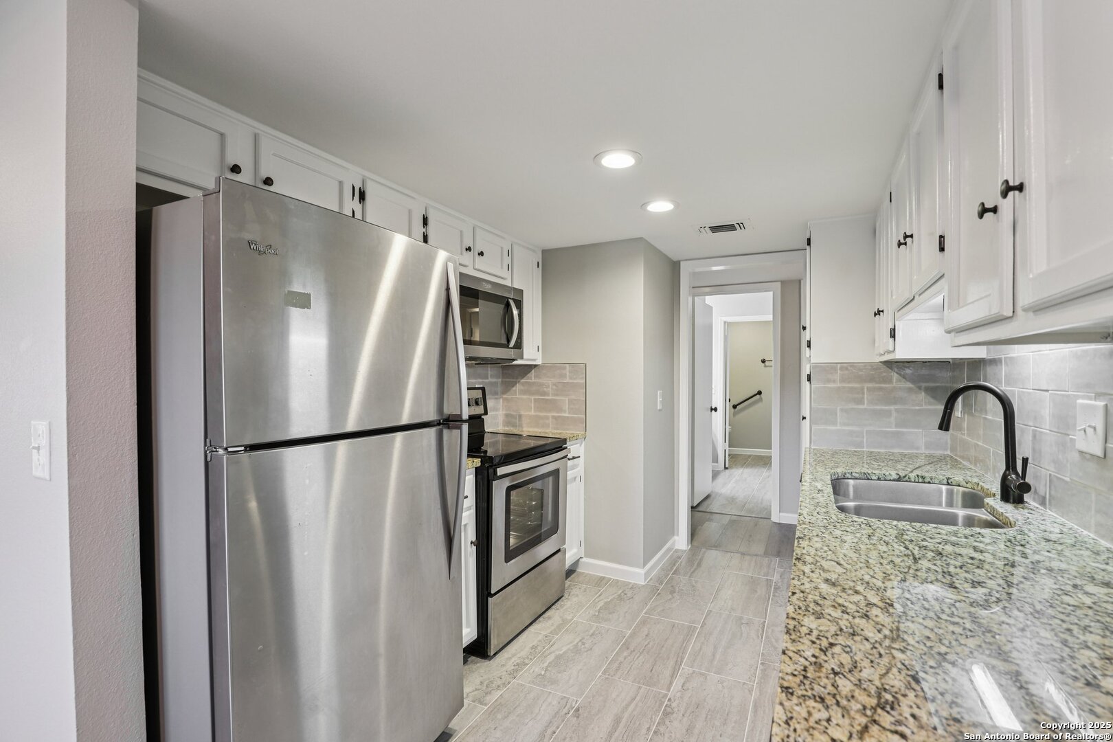3441 Turtle Village Drive, Unit 92FF San Antonio, TX 78230 - Photo 13 of 34 a kitchen with stainless steel appliances granite countertop a refrigerator sink and cabinets