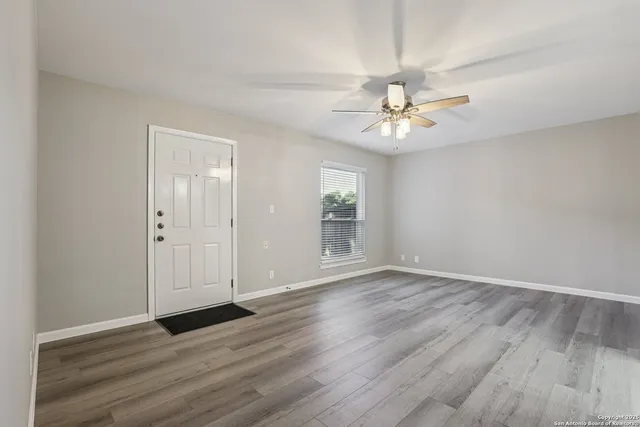 wooden floor in an empty room with a window