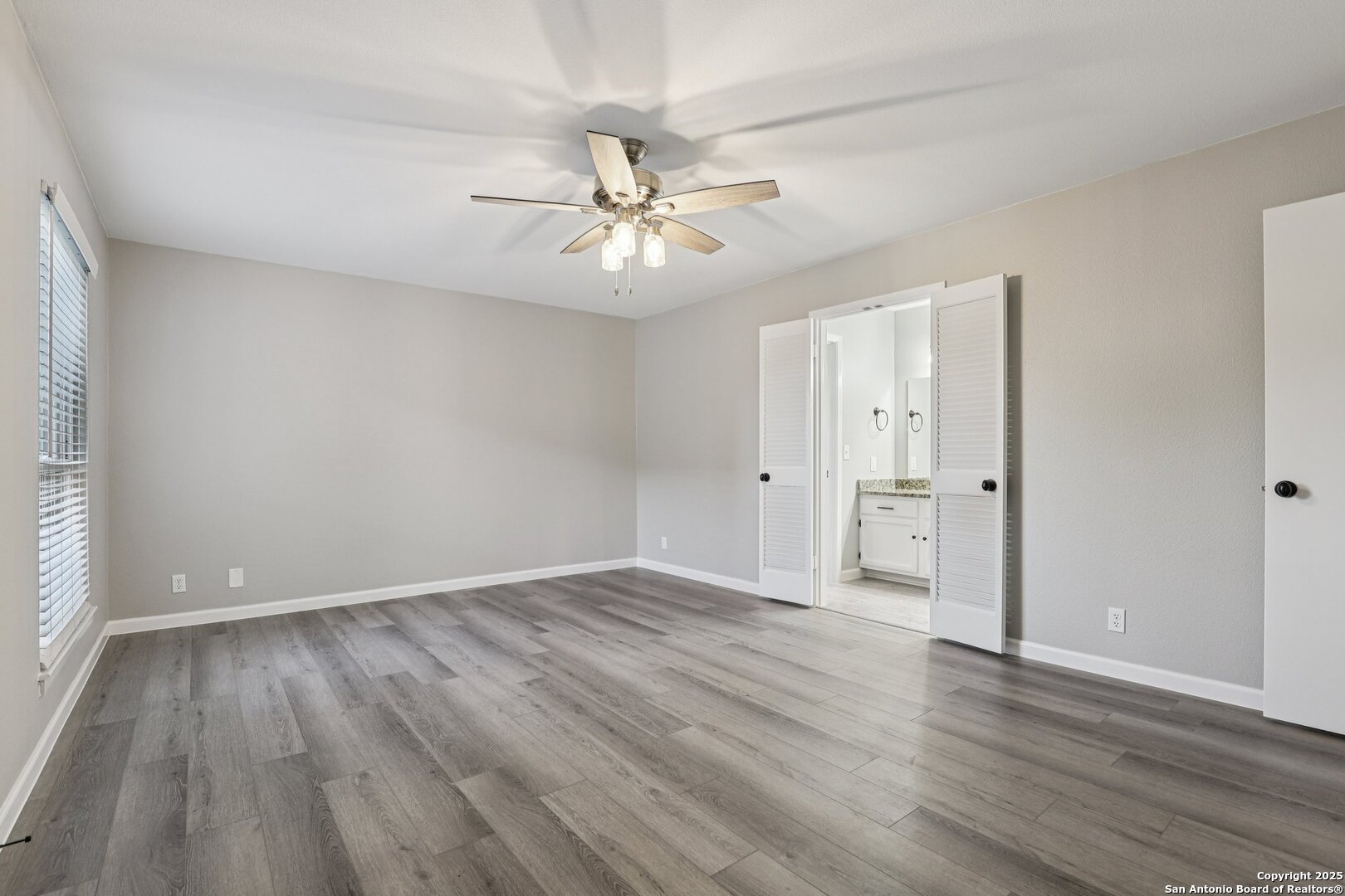 3441 Turtle Village Drive, Unit 92FF San Antonio, TX 78230 - Photo 17 of 34 an empty room with wooden floor and windows