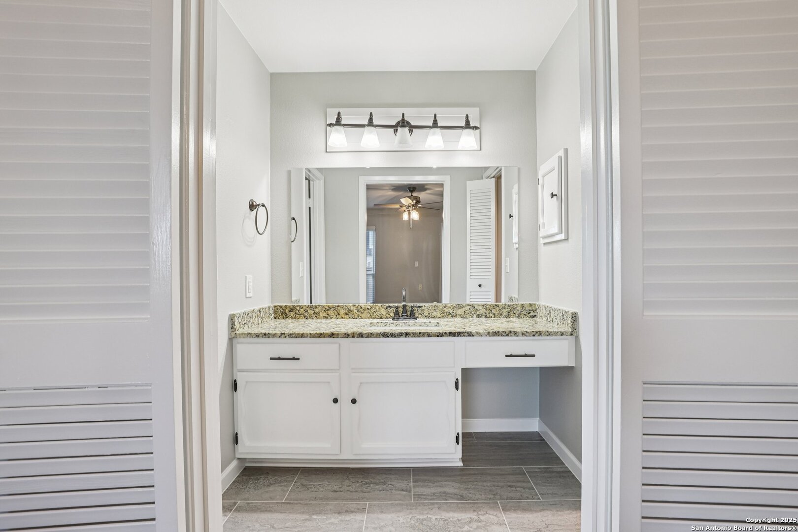 3441 Turtle Village Drive, Unit 92FF San Antonio, TX 78230 - Photo 19 of 34 a bathroom with a granite countertop sink and a mirror