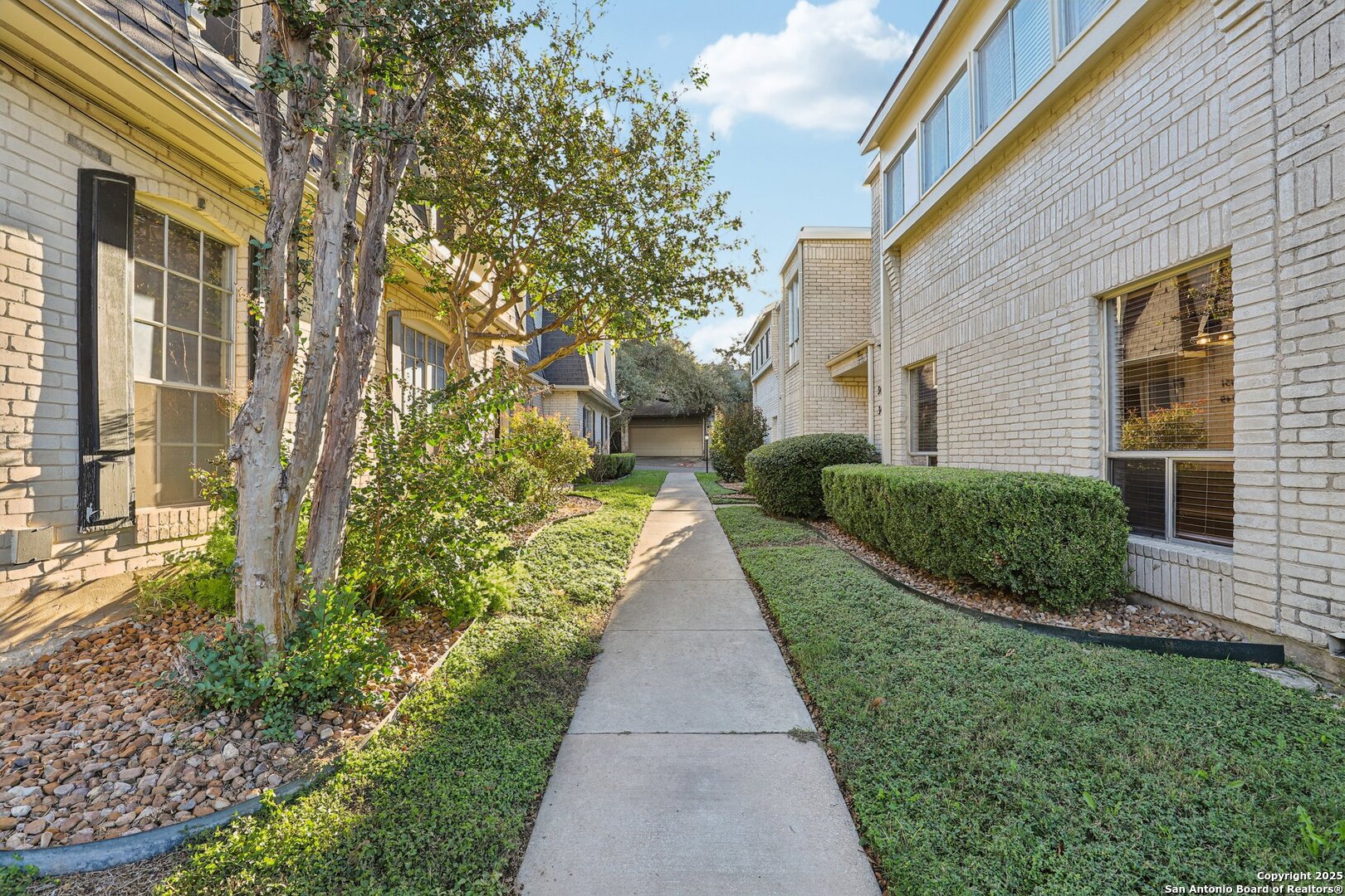 3441 Turtle Village Drive, Unit 92FF San Antonio, TX 78230 - Photo 2 of 34 a view of a pathway with a house in the background