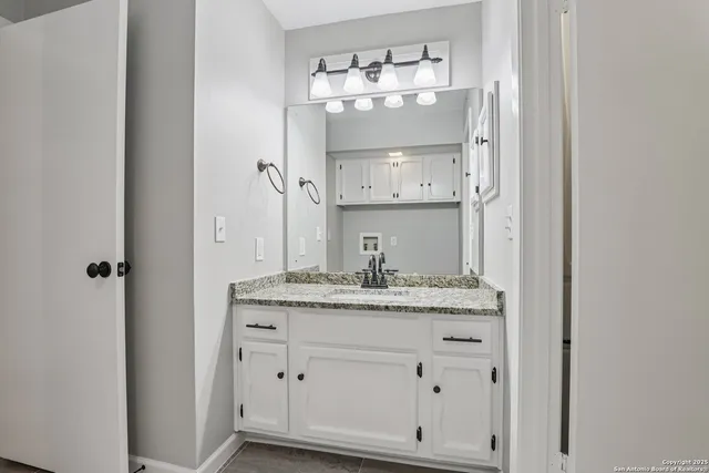 a bathroom with a sink and a mirror