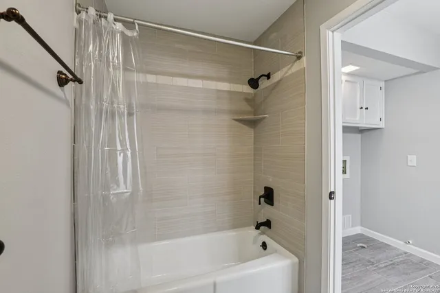 a bathroom with a bathtub and a shower