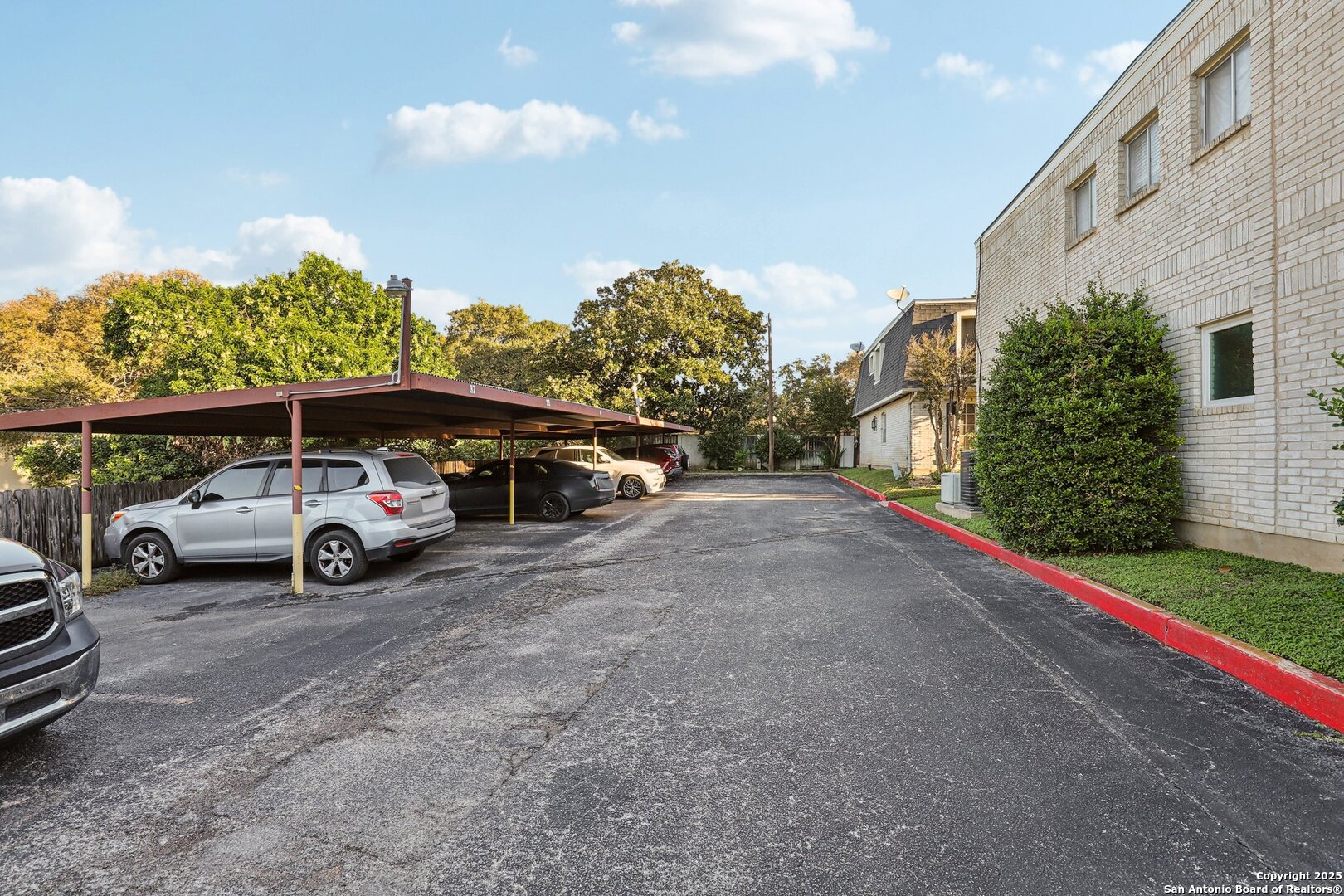 3441 Turtle Village Drive, Unit 92FF San Antonio, TX 78230 - Photo 30 of 34 a view of parking with cars parked