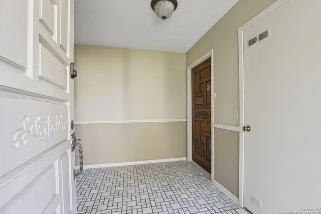 a view of a hallway with wooden shelves