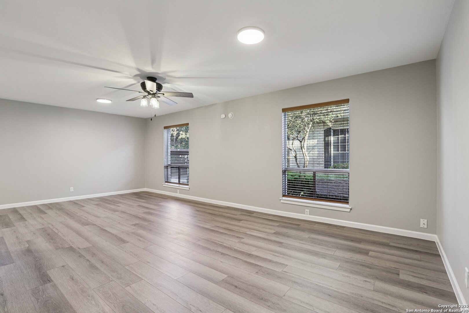3441 Turtle Village Drive, Unit 92FF San Antonio, TX 78230 - Photo 8 of 34 a view of an empty room with a window and wooden floor