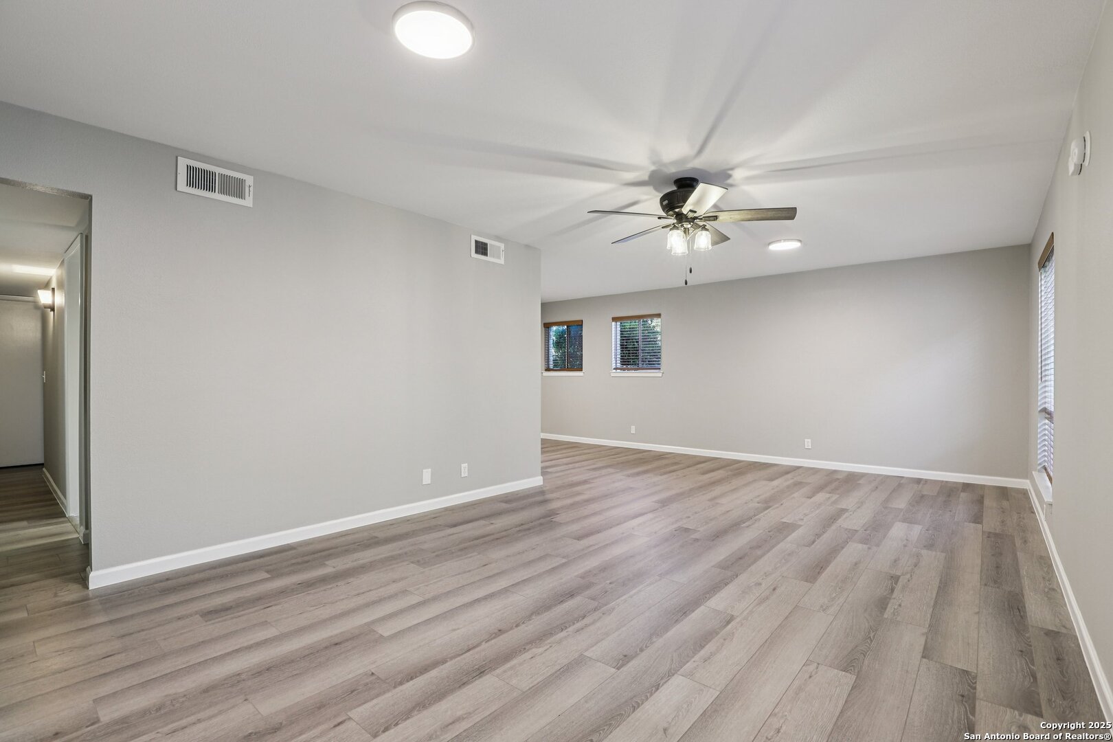 3441 Turtle Village Drive, Unit 92FF San Antonio, TX 78230 - Photo 9 of 34 wooden floor in an empty room with a window