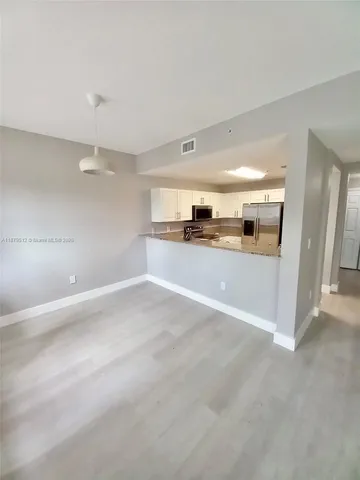 a view of a kitchen with a sink and a stove top oven
