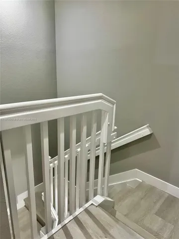a view of wooden floor with staircase