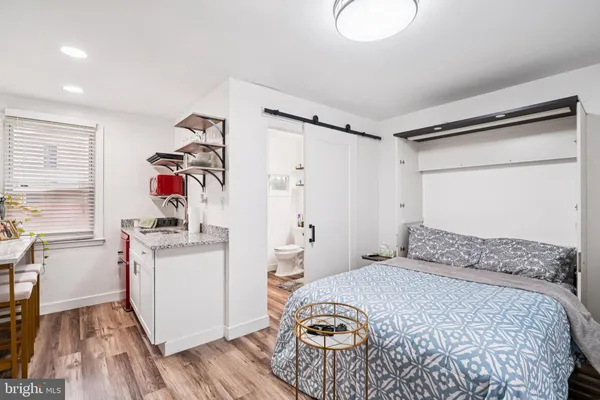 a bedroom with a bed and a dresser in it