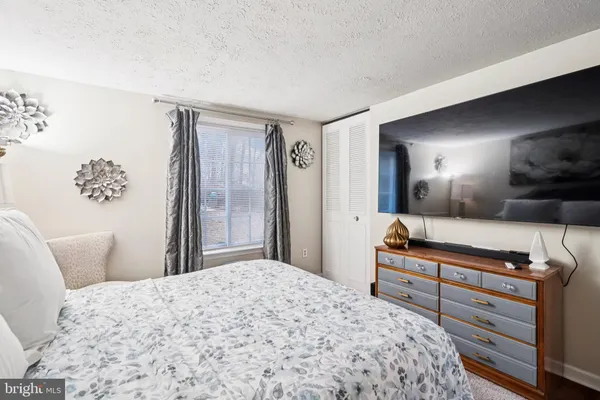 a bedroom with a bed and a mirror