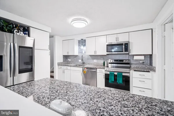 a kitchen with a sink stove and refrigerator