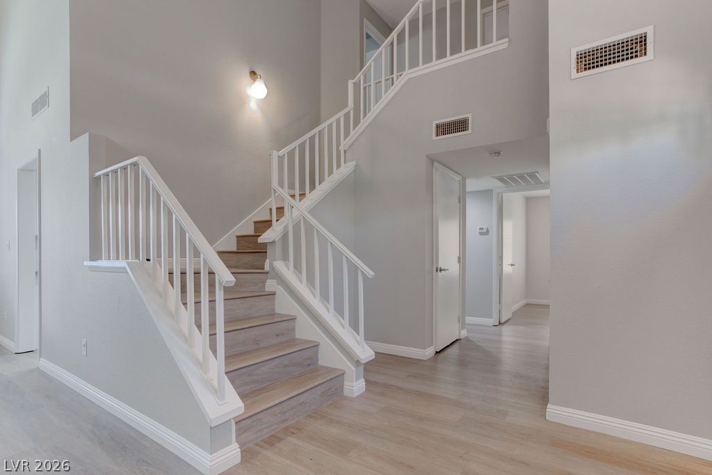 1416 Walstone Road North Las Vegas, NV 89031 - Photo 3 of 47 Ascend a gracious staircase with natural wood treads, leading to a light-filled upper level.