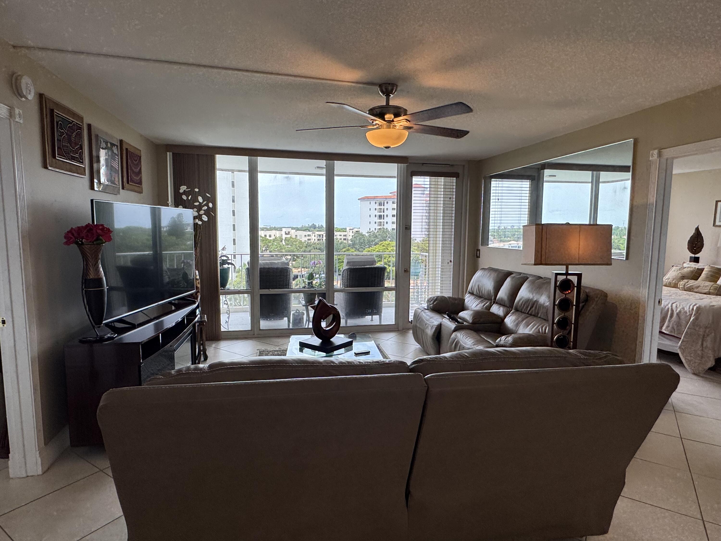 336 Golfview Road, Unit 706 North Palm Beach, FL 33408 - Photo 15 of 41 a living room with furniture a flat screen tv and a large window