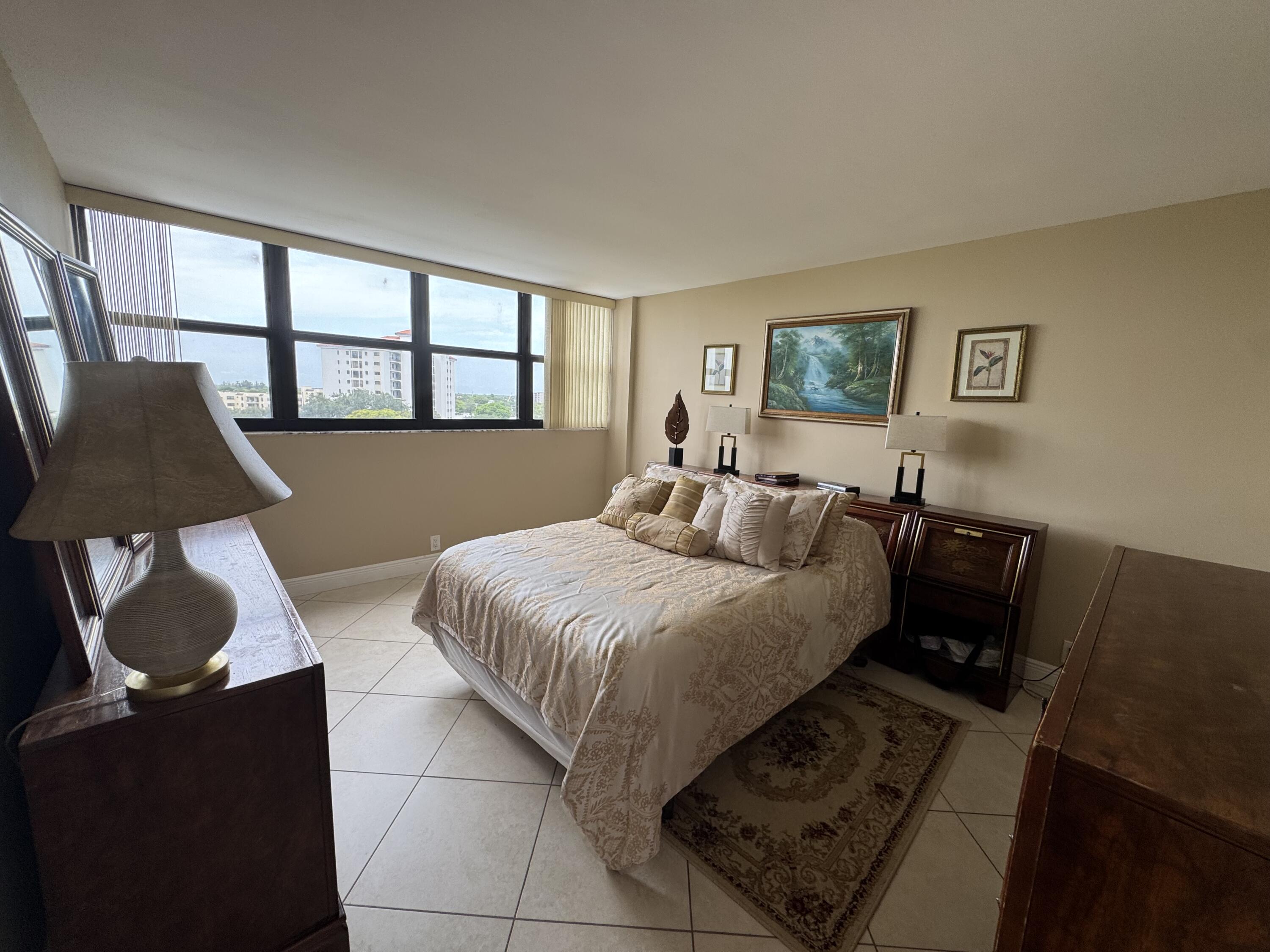 336 Golfview Road, Unit 706 North Palm Beach, FL 33408 - Photo 17 of 41 a bed sitting in a bedroom next to a window