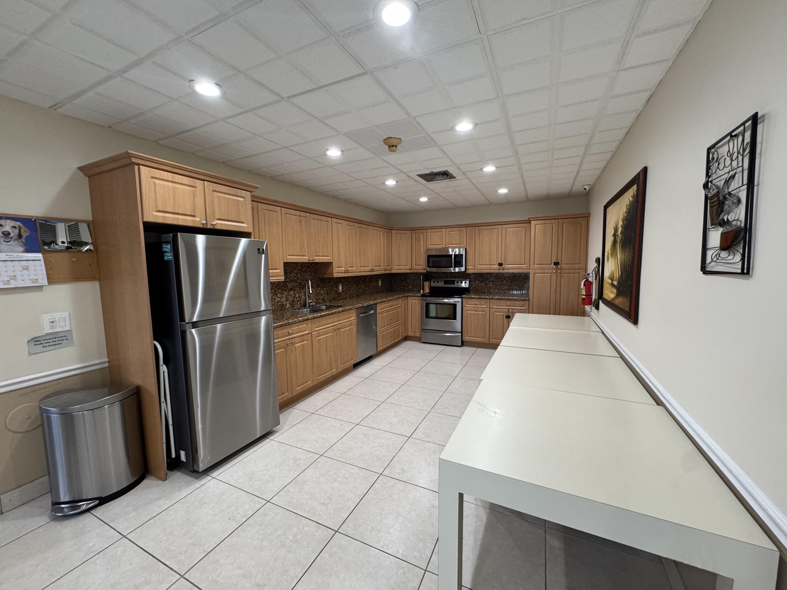 336 Golfview Road, Unit 706 North Palm Beach, FL 33408 - Photo 29 of 41 a large kitchen with a large counter top stainless steel appliances and cabinets