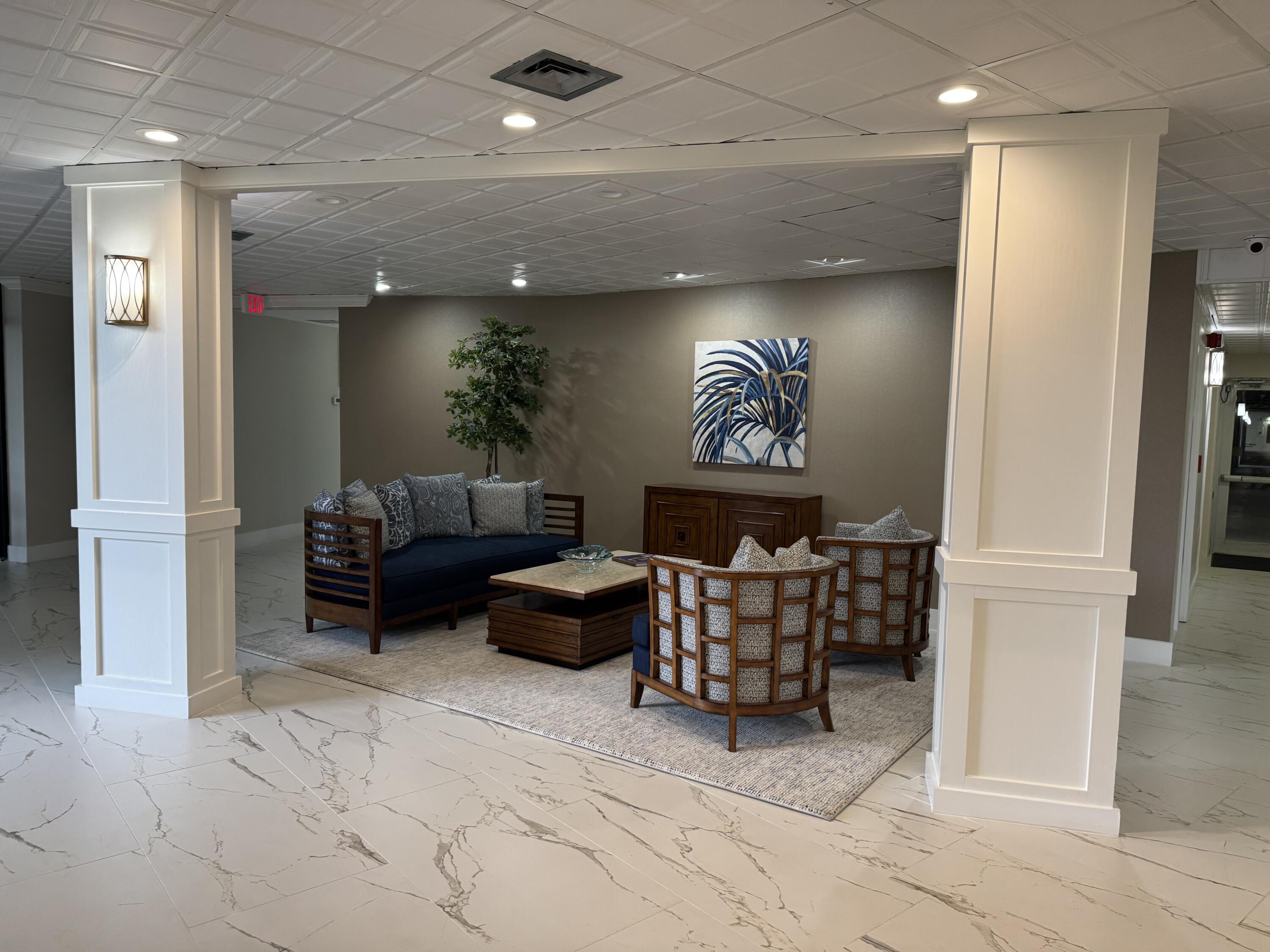 336 Golfview Road, Unit 706 North Palm Beach, FL 33408 - Photo 33 of 41 a living room with furniture and a fireplace
