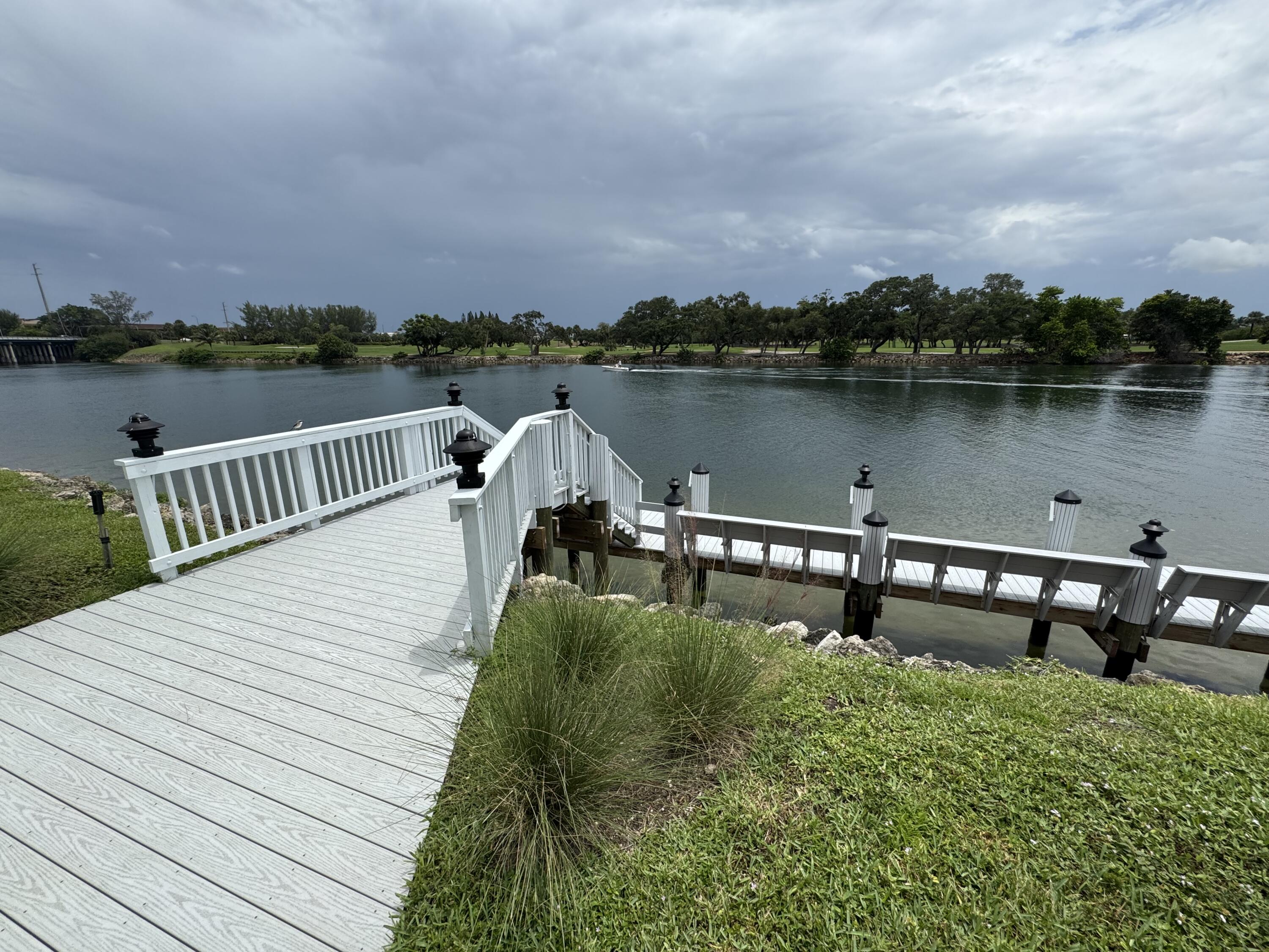336 Golfview Road, Unit 706 North Palm Beach, FL 33408 - Photo 4 of 41 a view of a lake with houses in the background