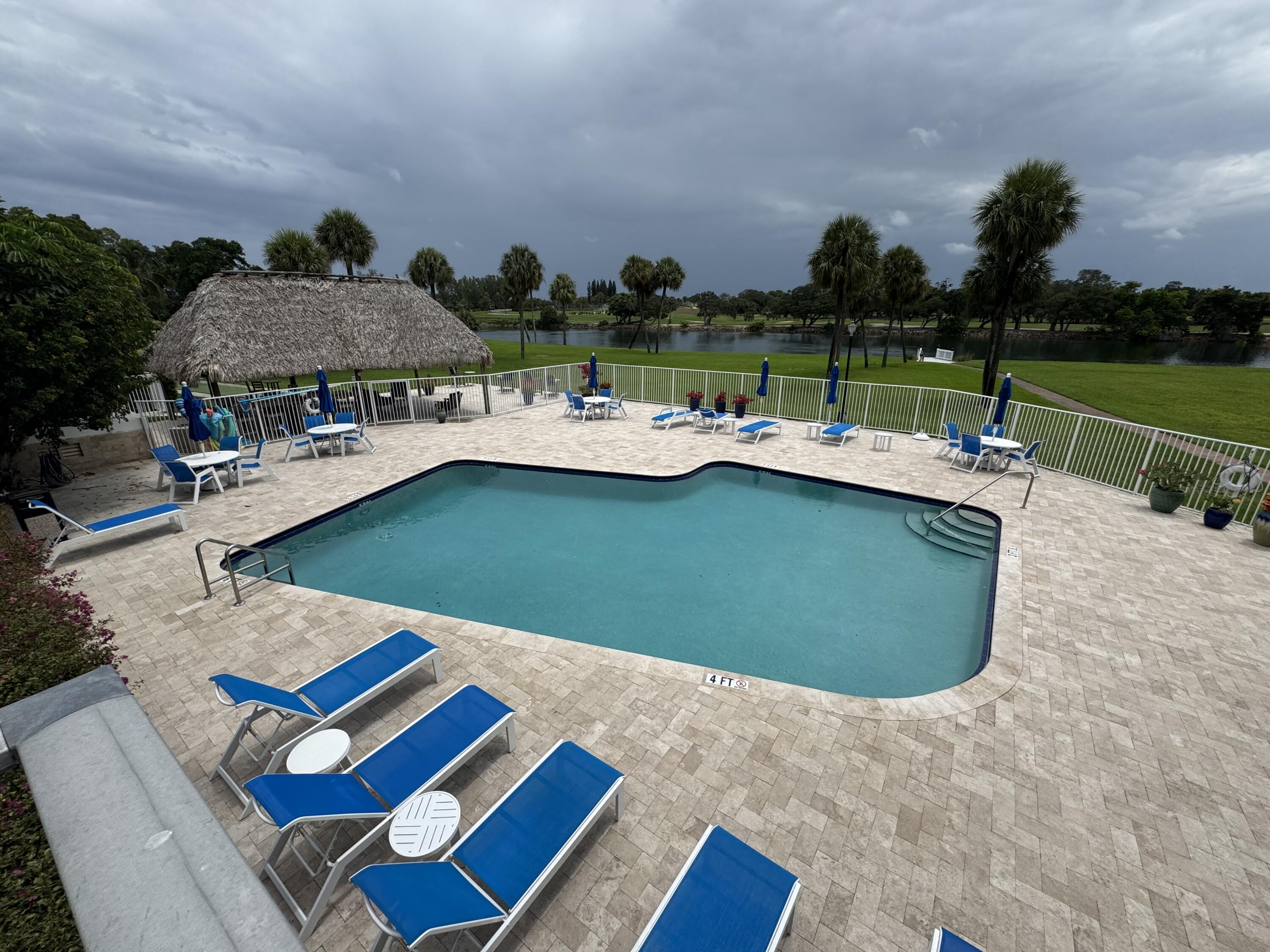 336 Golfview Road, Unit 706 North Palm Beach, FL 33408 - Photo 6 of 41 a view of swimming pool with outdoor seating and a garden