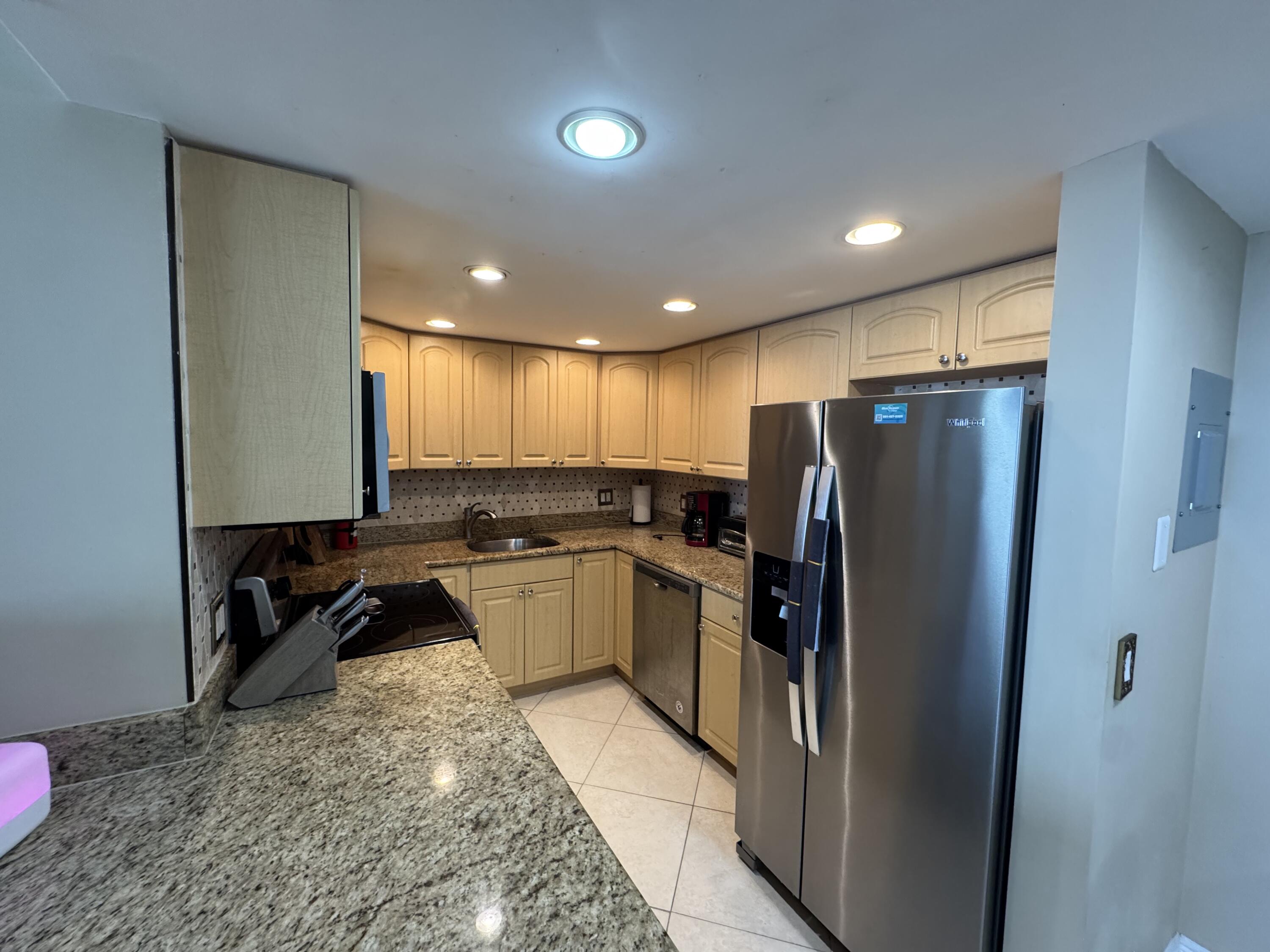 336 Golfview Road, Unit 706 North Palm Beach, FL 33408 - Photo 9 of 41 a kitchen with a refrigerator and a sink