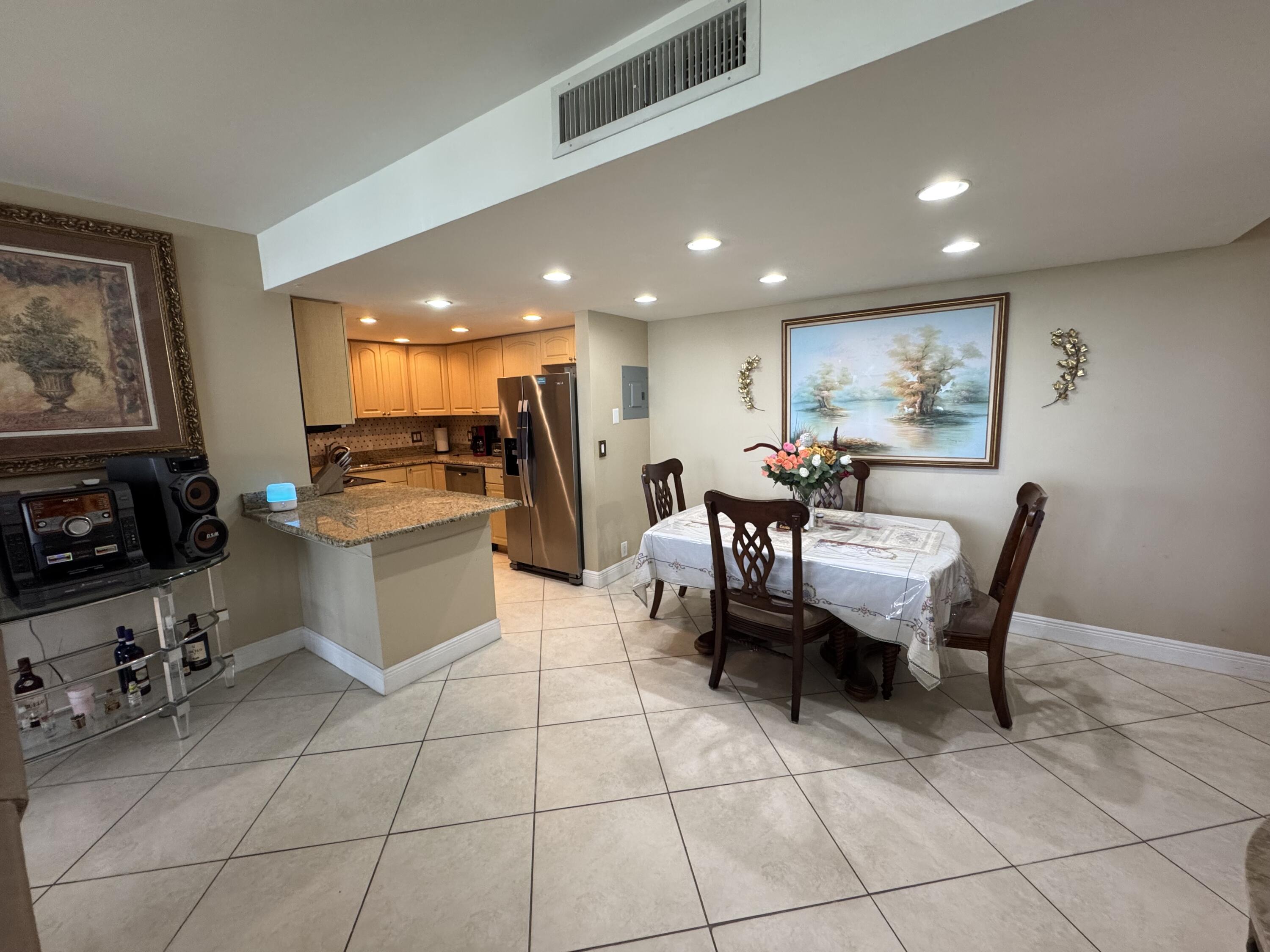336 Golfview Road, Unit 706 North Palm Beach, FL 33408 - Photo 10 of 41 a view of a dining room with furniture