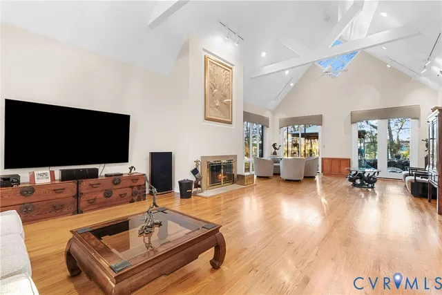 a kitchen with stainless steel appliances kitchen island granite countertop a table chairs and a refrigerator