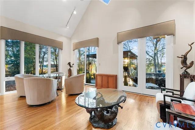 a kitchen with stainless steel appliances kitchen island granite countertop a table chairs and a refrigerator