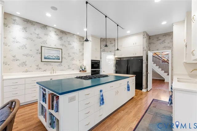 a en suite bathroom with a granite countertop tub shower and a sink
