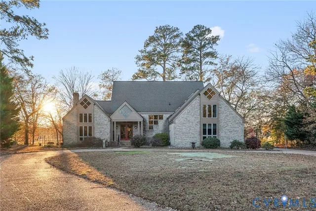 a living room with couches and a dining table with wooden floor