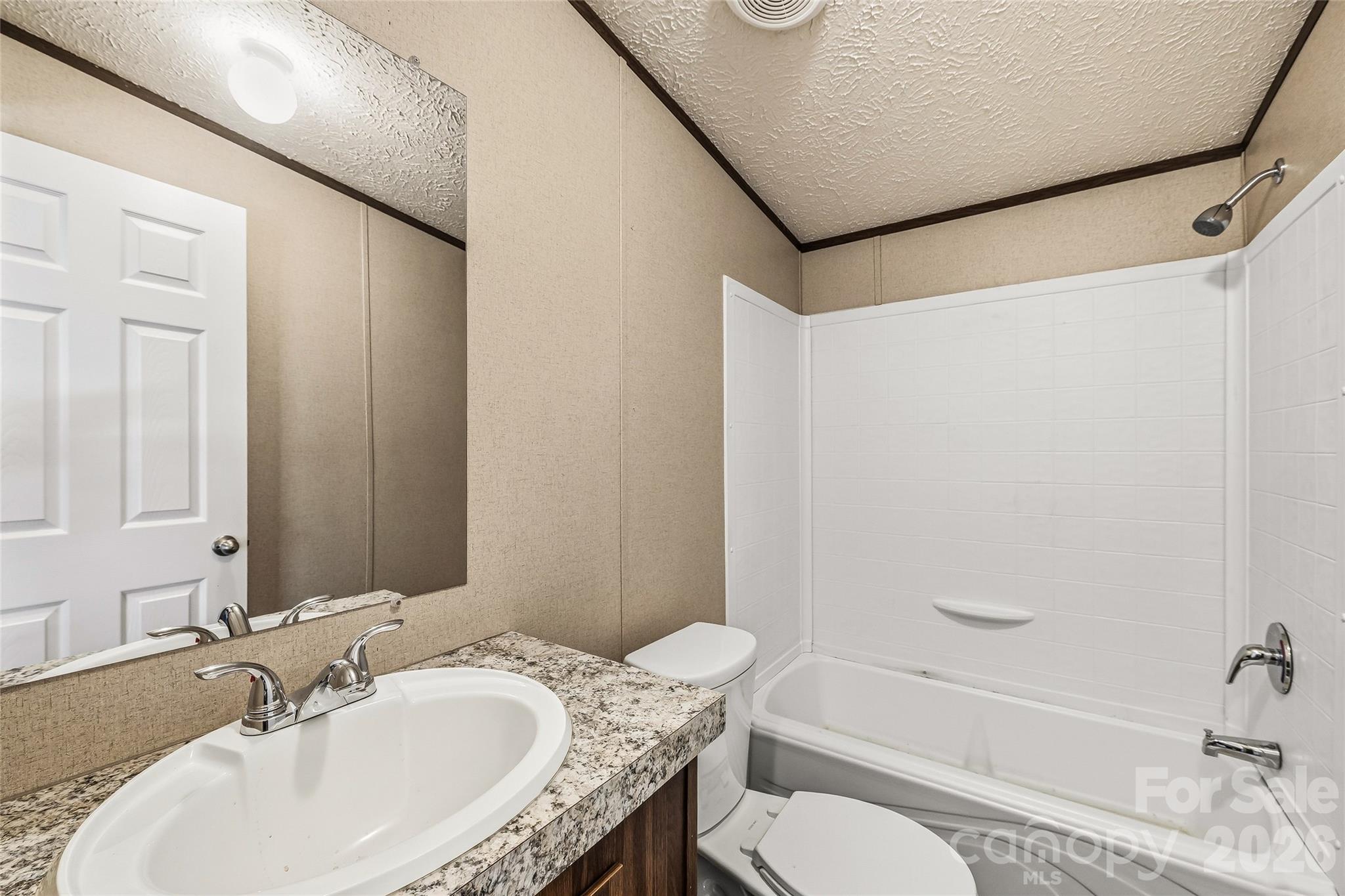 45 Alan Retreat Road Hendersonville, NC 28792 - Photo 22 of 25 a bathroom with a granite countertop sink toilet and shower