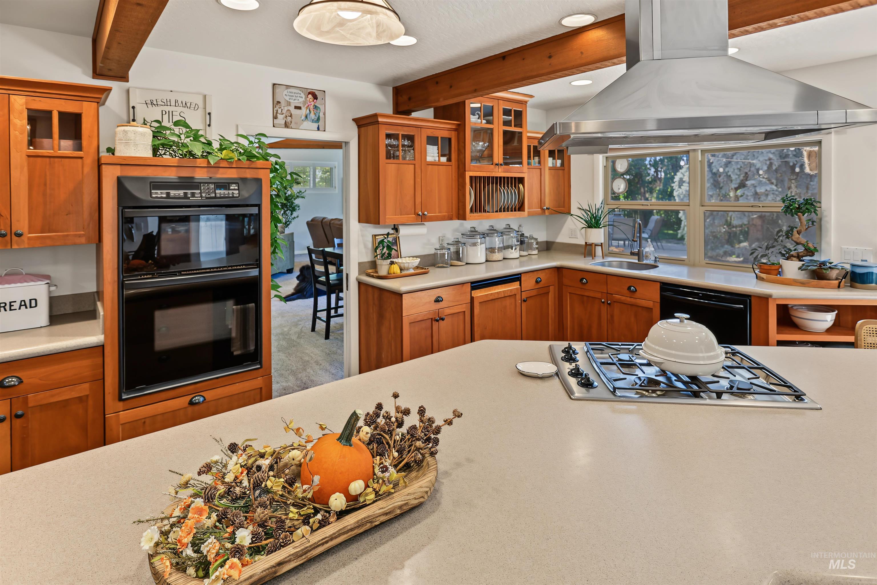 508 East Elm Avenue Parma, ID 83660 - Photo 10 of 50 Open-concept kitchen featuring wood cabinetry, stainless steel range hood, integrated gas cooktop, built-in double oven, and recessed lighting
