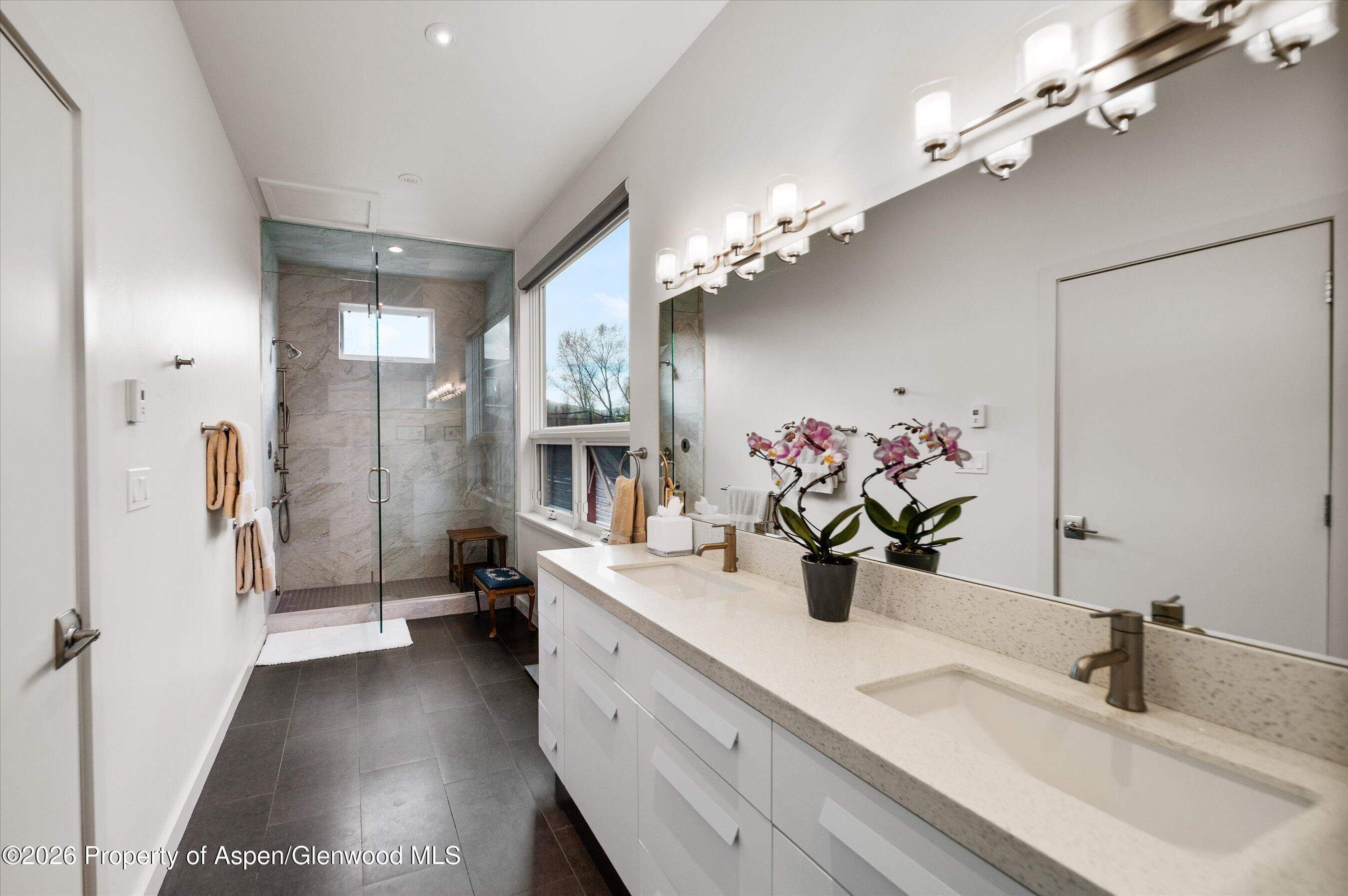 350 Sopris Circle Basalt, CO 81621 - Photo 15 of 49 a bathroom with a double vanity sink mirror and shower