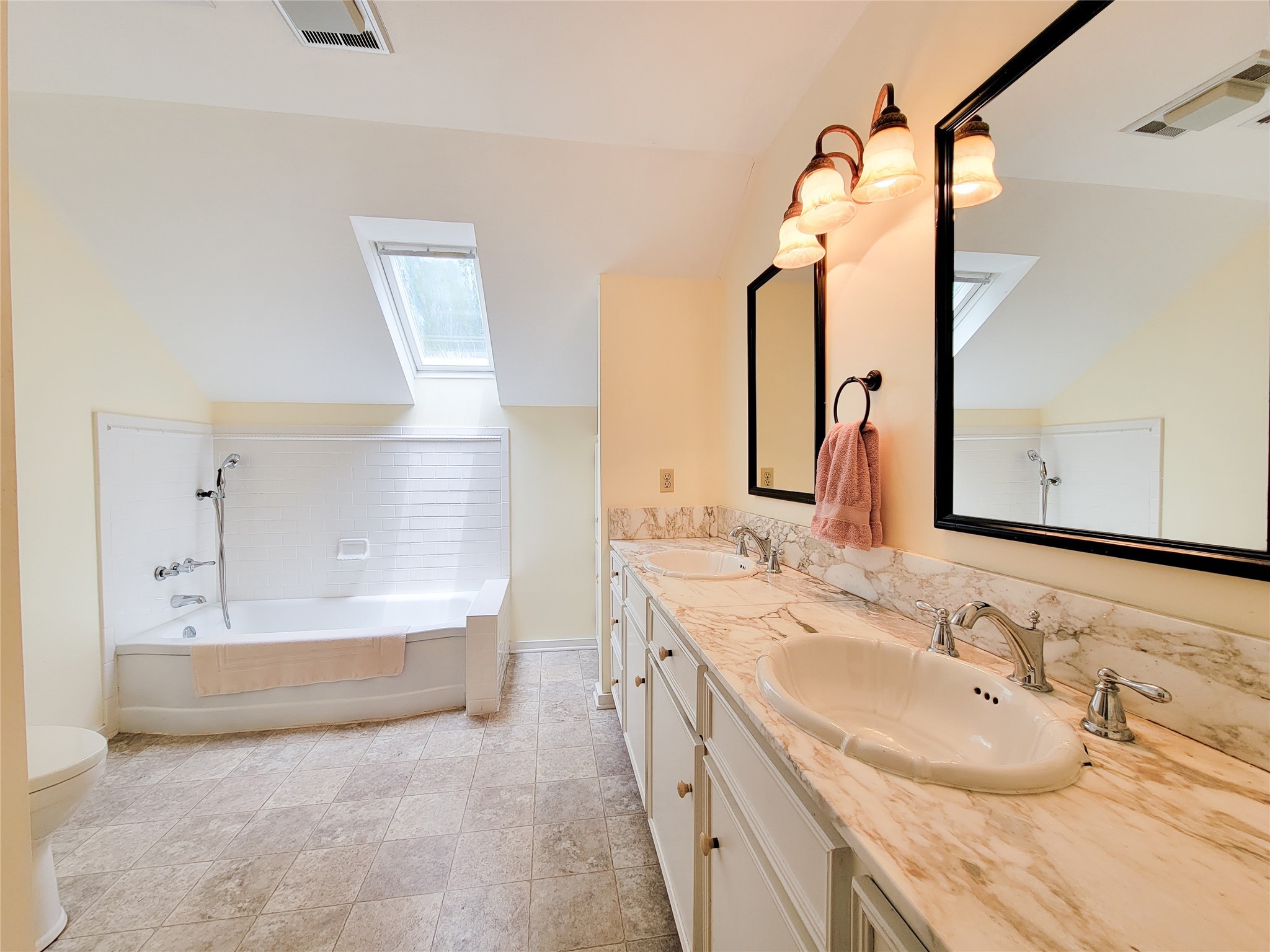 1406 Key Street Brenham, TX 77833 - Photo 27 of 50 a bathroom with a tub sink and mirror