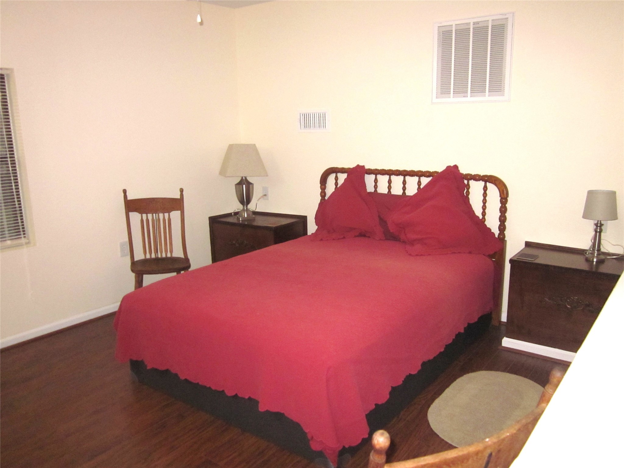 1406 Key Street Brenham, TX 77833 - Photo 47 of 50 a bedroom with a bed and a lamp with wooden floor