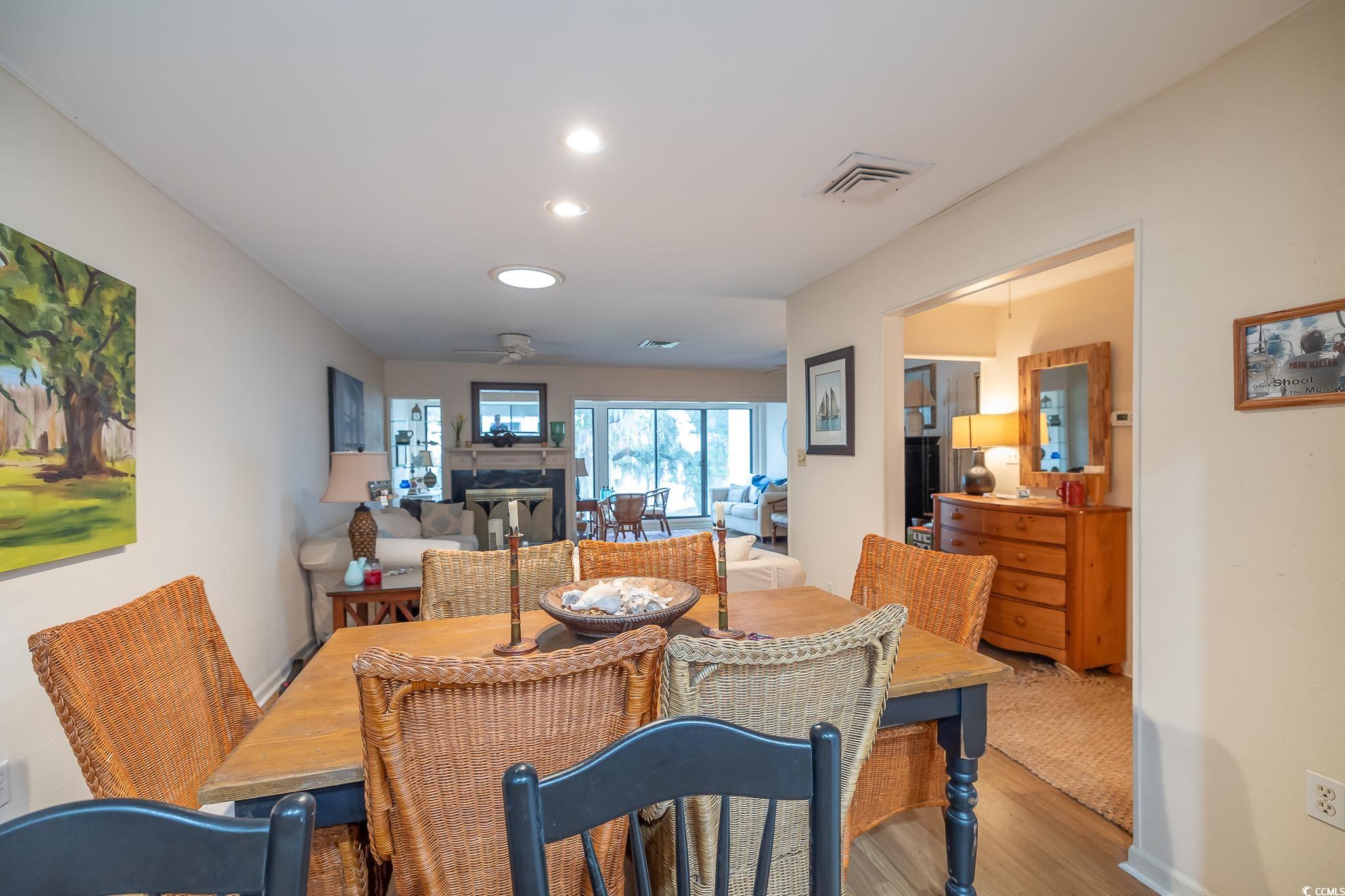 30 Little Point Road, Unit 32 Georgetown, SC 29440 - Photo 20 of 30 Dining room with wood finished floors, a fireplace, and recessed lighting