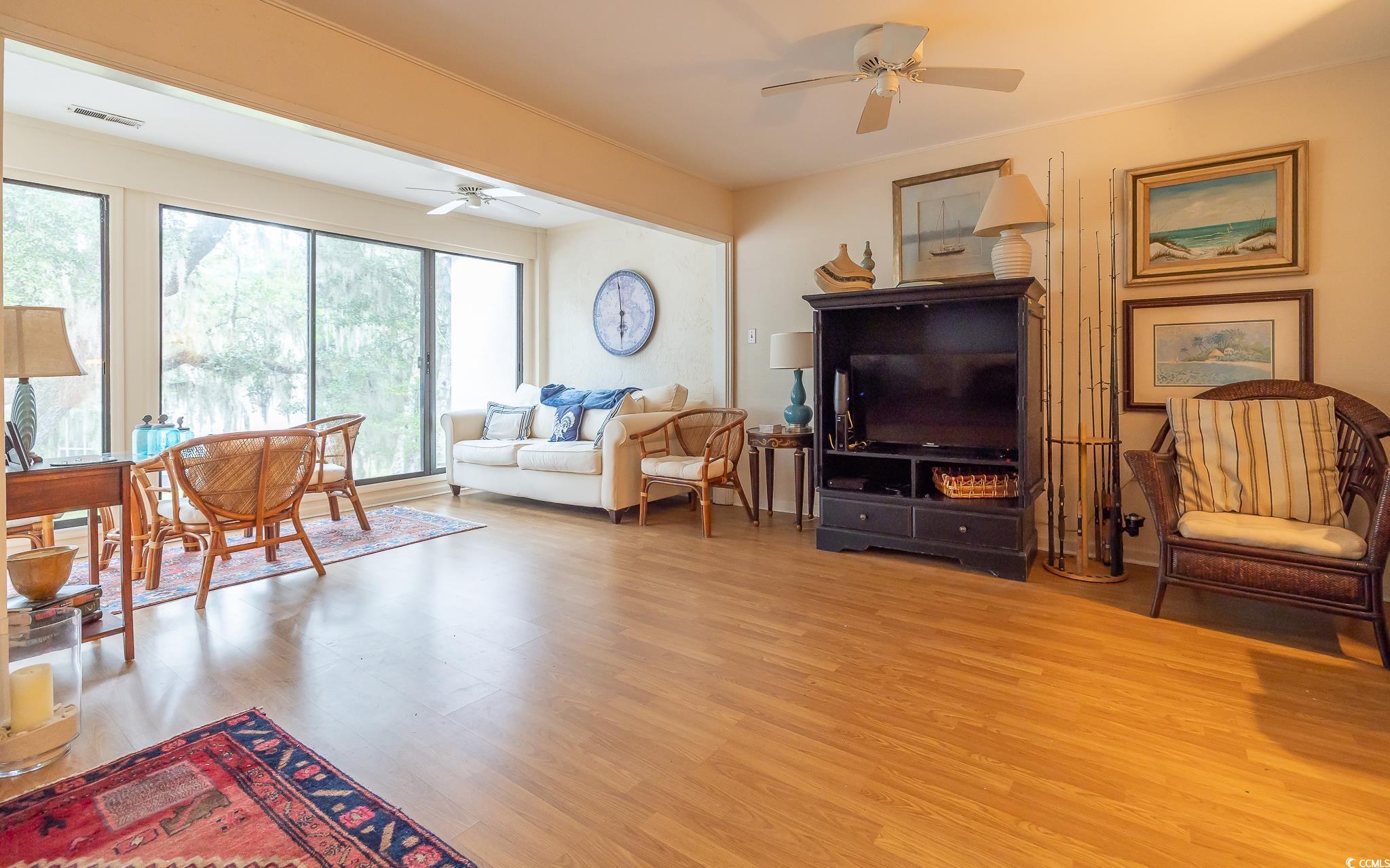 30 Little Point Road, Unit 32 Georgetown, SC 29440 - Photo 23 of 30 Living area with wood finished floors, a ceiling fan, and crown molding