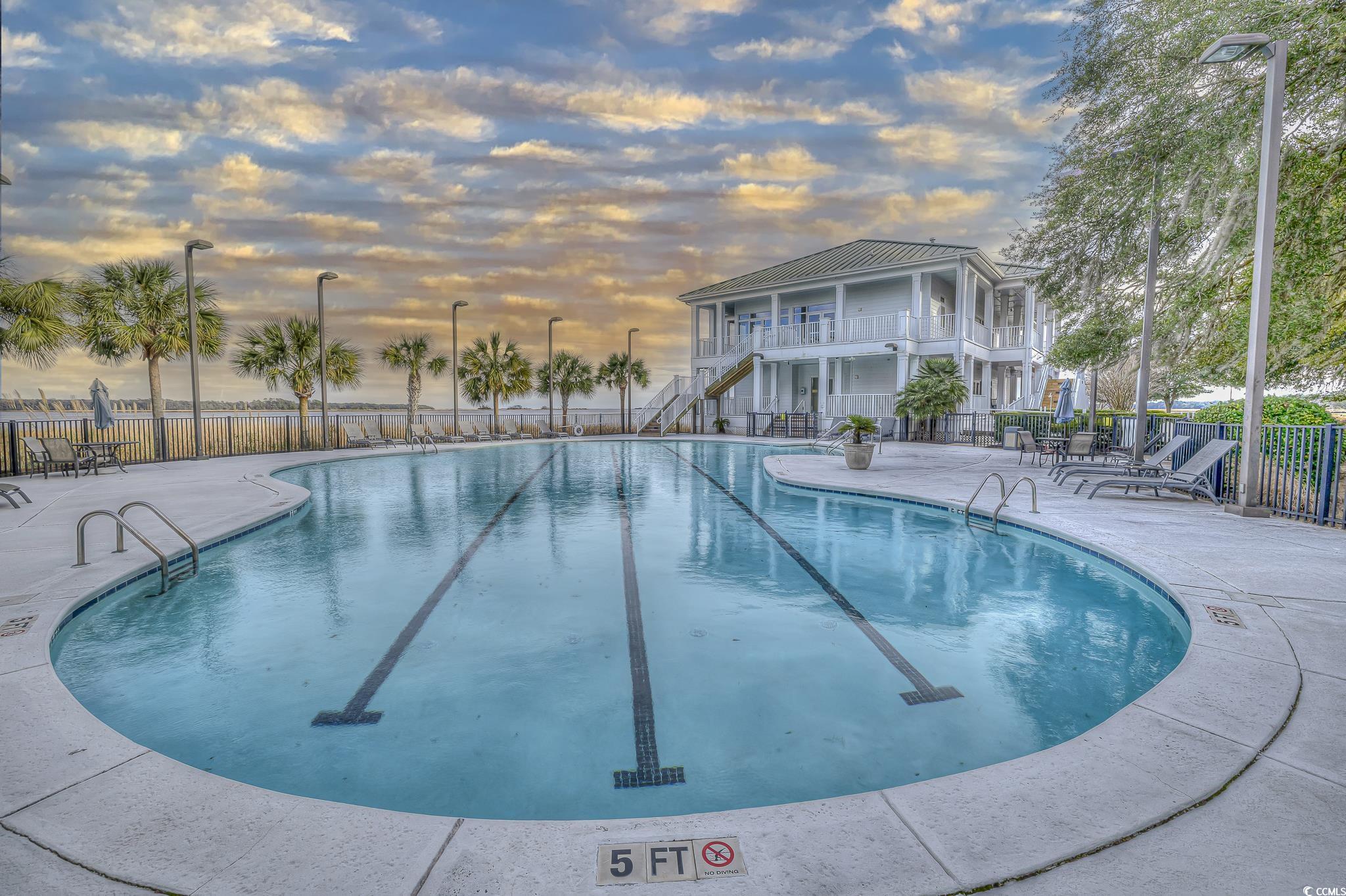 30 Little Point Road, Unit 32 Georgetown, SC 29440 - Photo 25 of 30 Pool at dusk with a patio area, stairway, a community pool, and a balcony