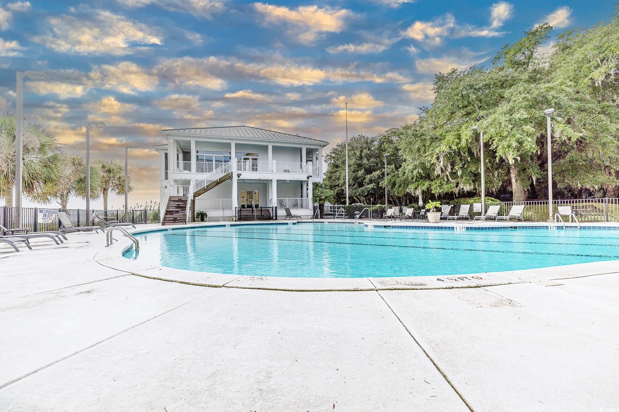 30 Little Point Road, Unit 32 Georgetown, SC 29440 - Photo 5 of 30 Pool at dusk with a patio, stairs, and a community pool