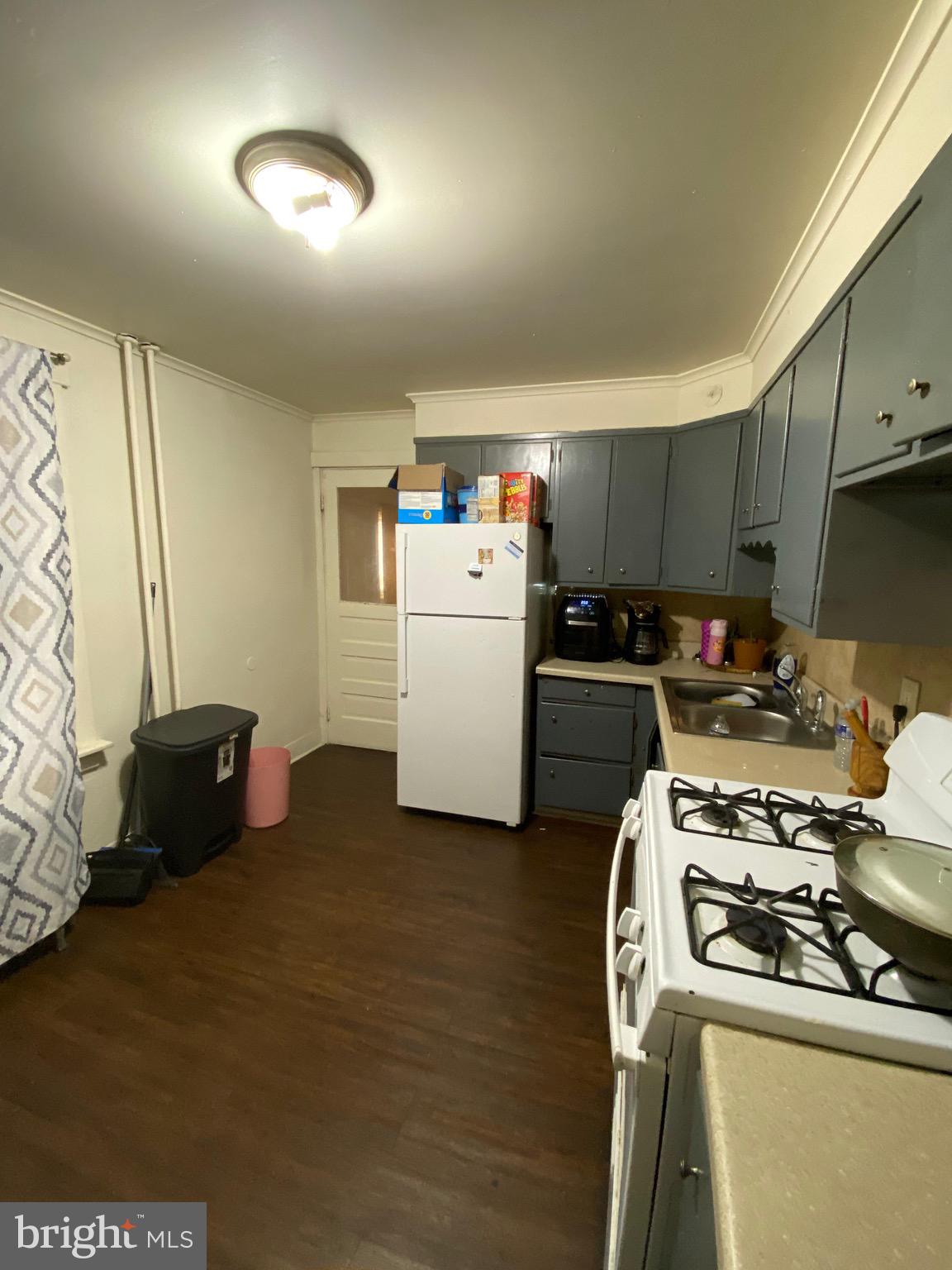 1047 Cotton Street Reading, PA 19602 - Photo 4 of 4 a kitchen with a refrigerator and a stove top oven
