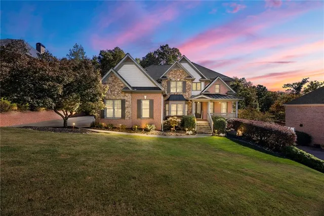 a front view of a house with swimming pool having outdoor seating