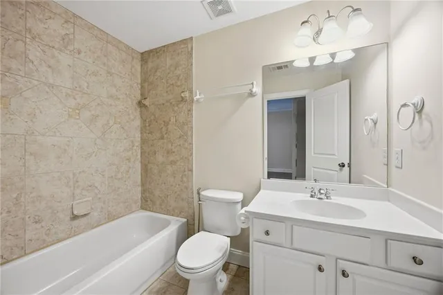 a bathroom with white cabinets