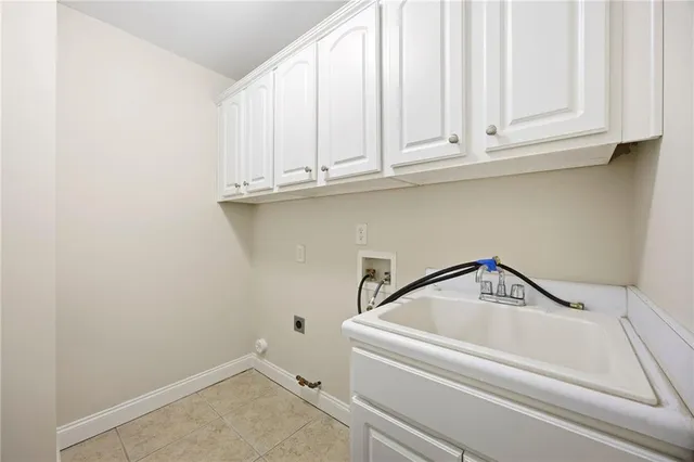 a view of an empty room with wooden floor and fan
