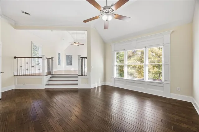 a view of empty room with wooden floor