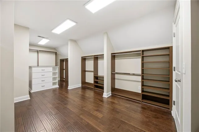 a view of a room with wooden floor and ceiling fan