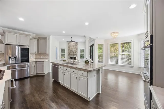 a kitchen with stainless steel appliances granite countertop a stove and cabinets
