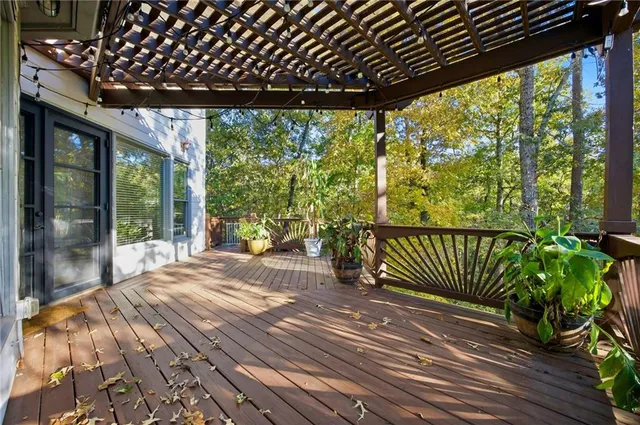 a front view of house with yard and trees in the background