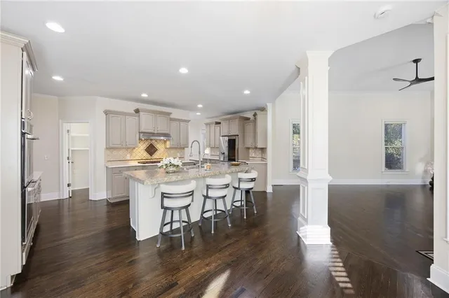 a kitchen with white cabinets and stainless steel appliances