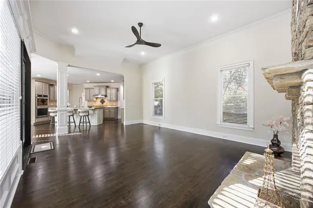 a view of empty room with wooden floor and fireplace