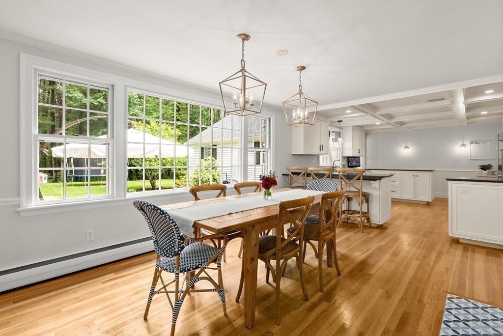49 Sears Road Wayland, MA 01778 - Photo 11 of 30 a view of a dining room and livingroom with furniture wooden floor a chandelier